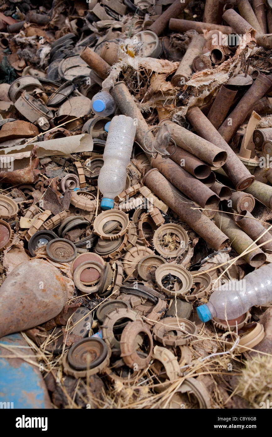 Parts of land mines and artillery and mortar shells lie rusting in the sun in a scrap yard in Iraq. Stock Photo