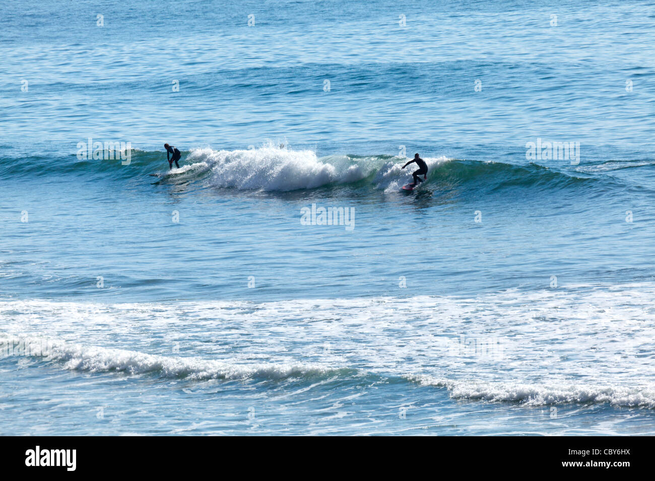 Two surfers catching a wave during the annual ONeill Surfing Contest in