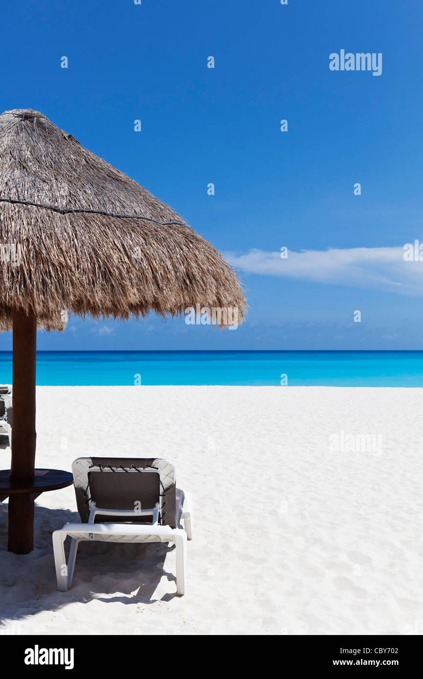 Umbrella and lounge chair on white sandy beach of Cancun Mexico Stock Photo