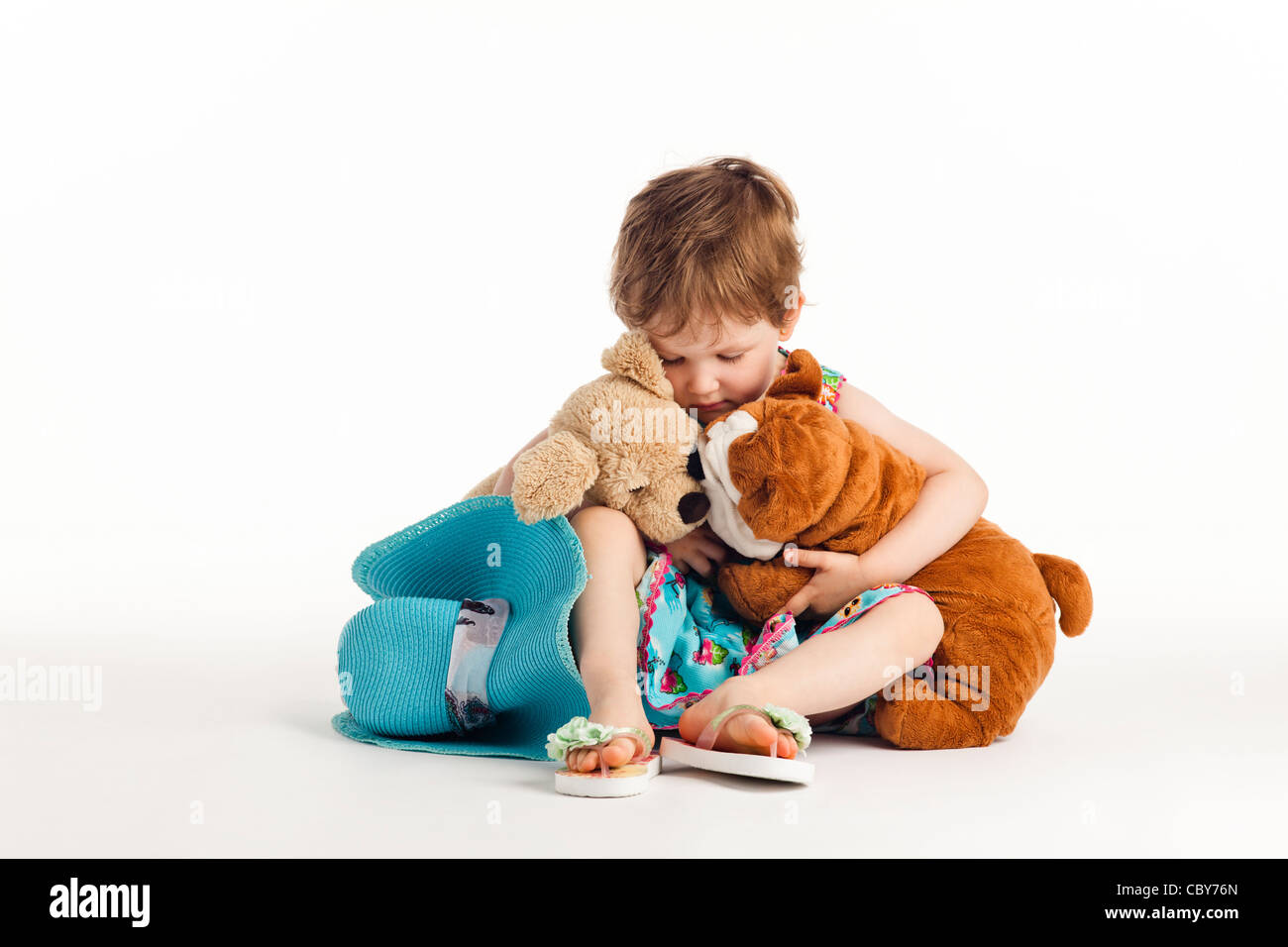Sad Child with stuffed animals Stock Photo