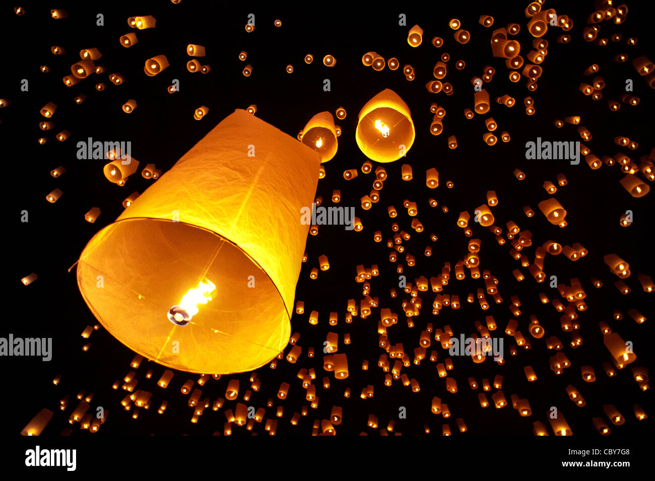 Traditional fire lanterns being released into the night sky during the