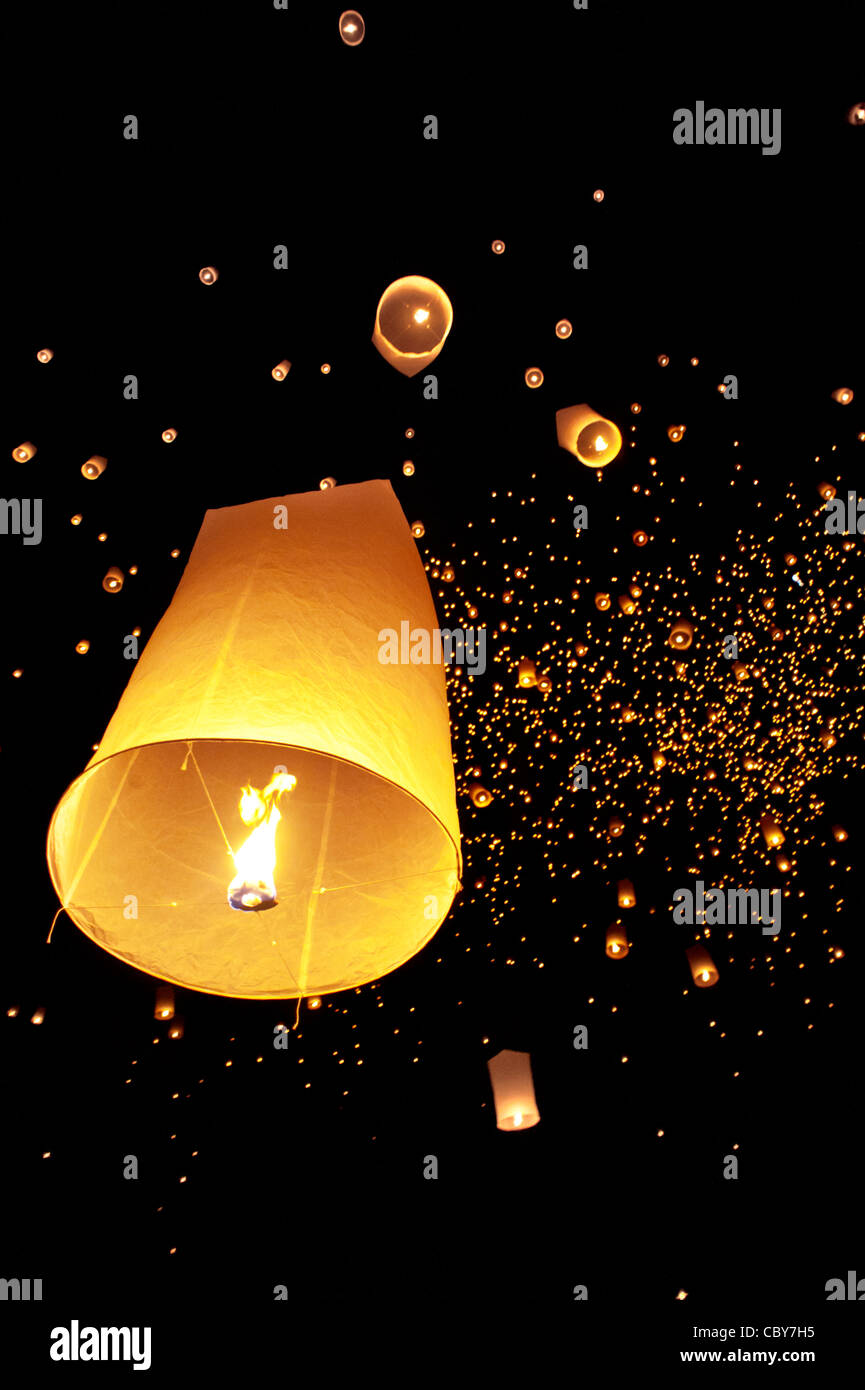 Traditional fire lanterns being released into the night sky during the