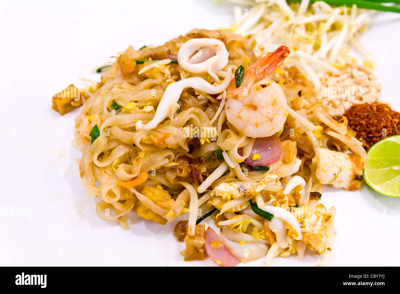 Seafood pad Thai dish of fried rice noodles on a white plate Stock Photo
