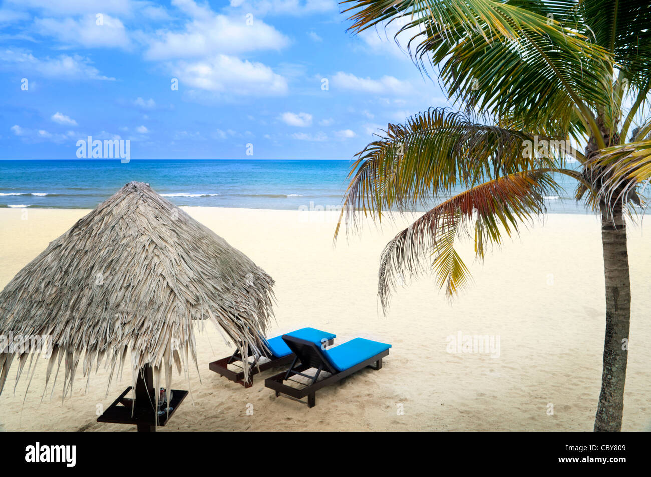 Tropical beach with hut and chairs Stock Photo Alamy