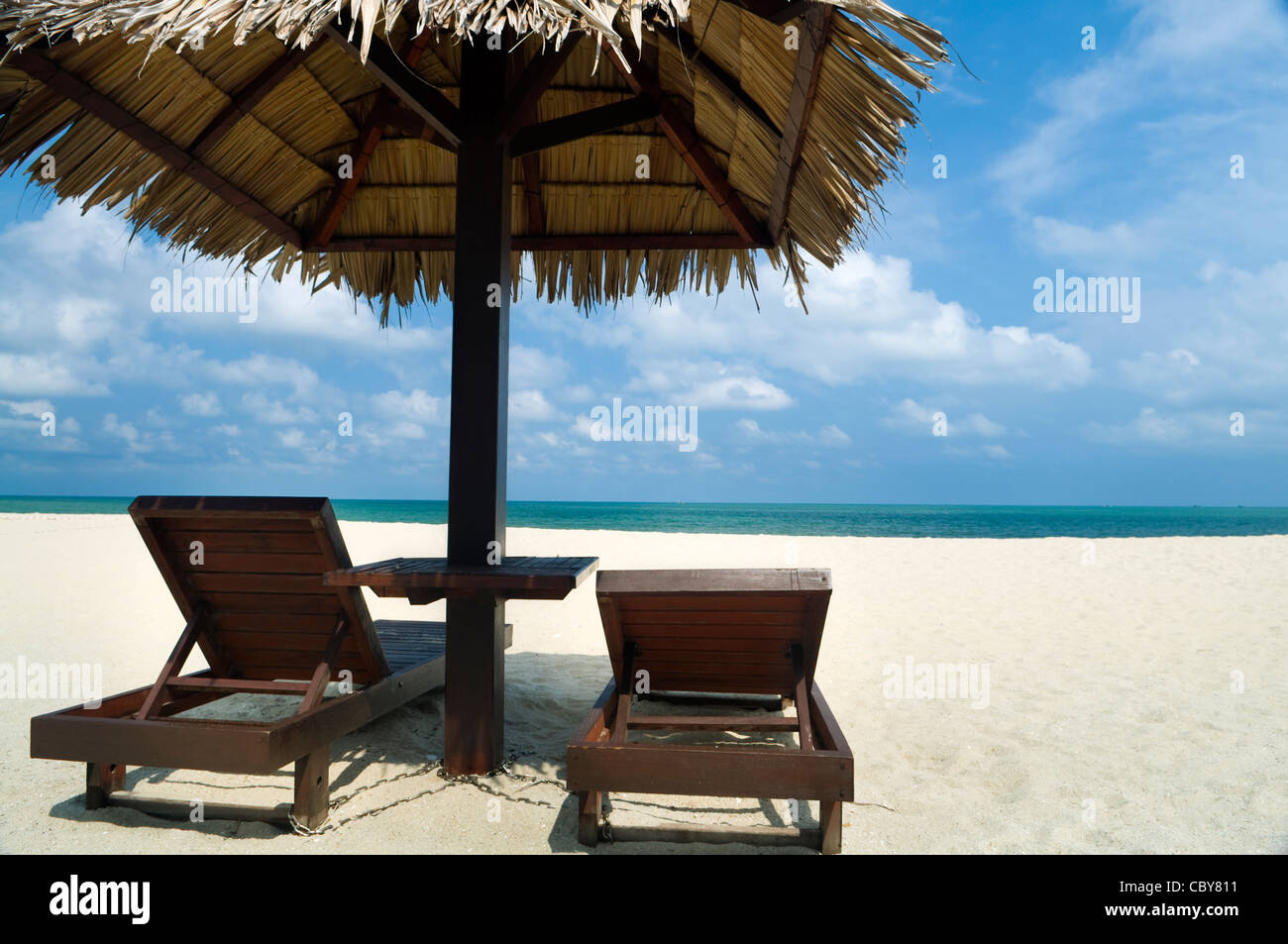 Tropical beach with hut and chairs Stock Photo Alamy
