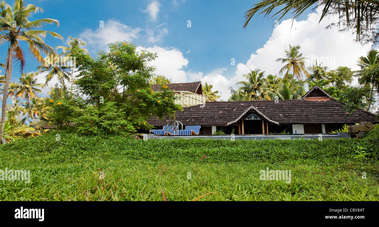 Panoramic view of an executive Bungalow of region styling with eternity swimming pool and well laid out mature gardens Stock Photo