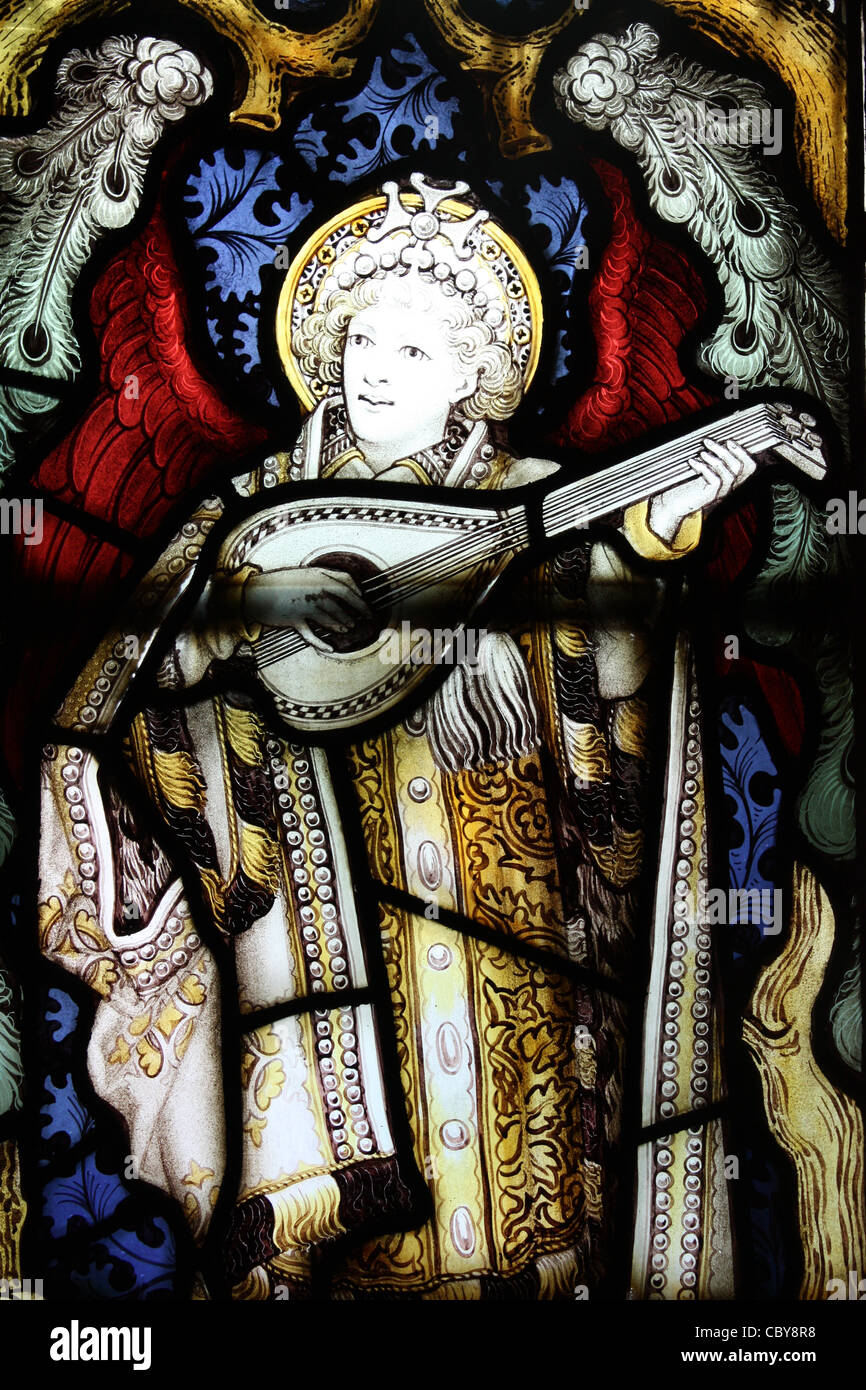 Instrumental angel in stained glass window in a chapel within Lichfield Cathedral Stock Photo