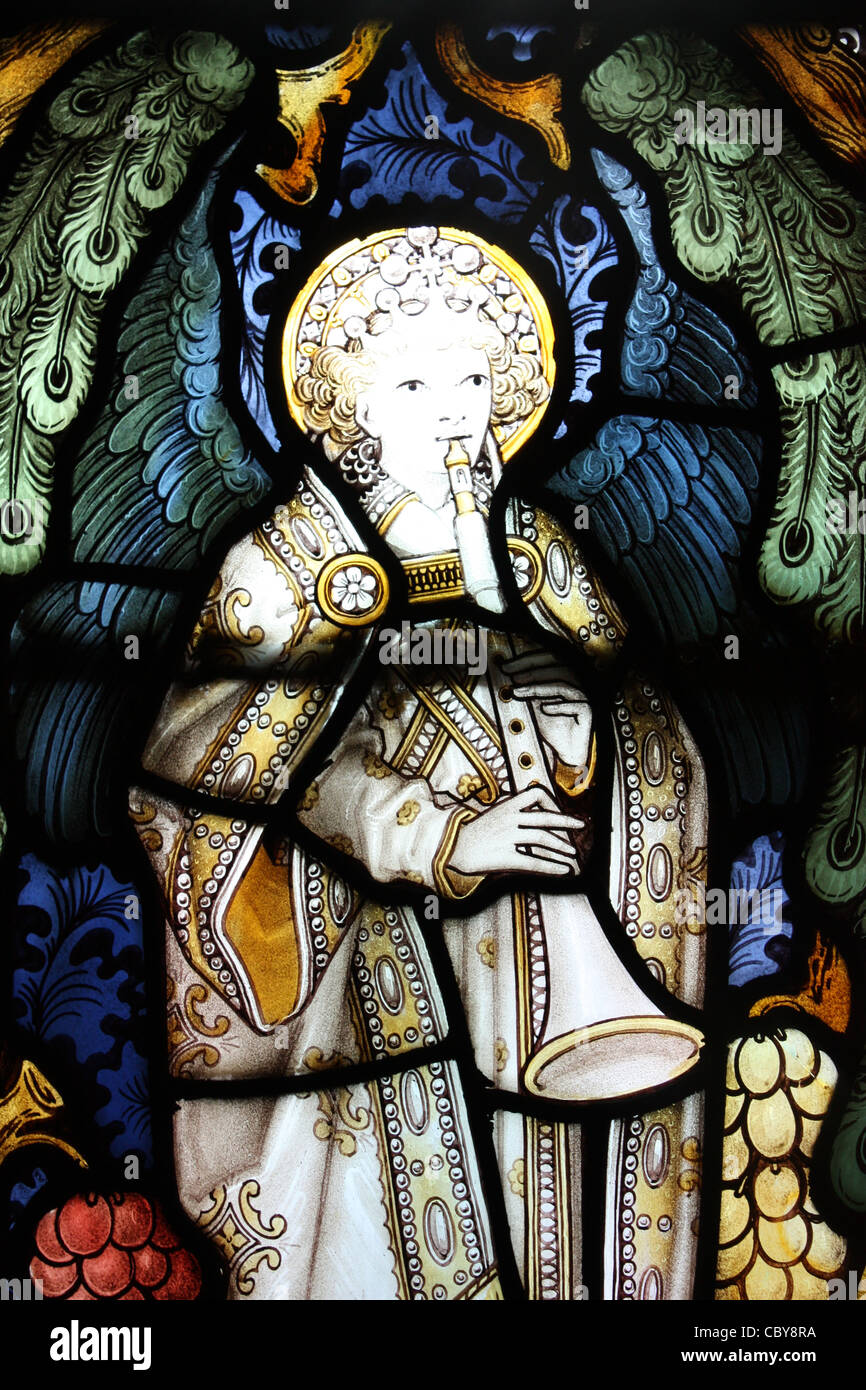 Instrumental angel in stained glass window in a chapel within Lichfield Cathedral Stock Photo