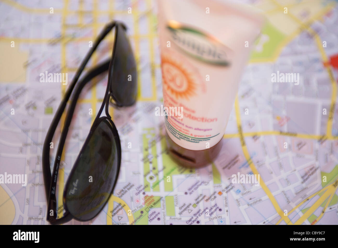 Travel: sunglasses, map and sunscreen Stock Photo