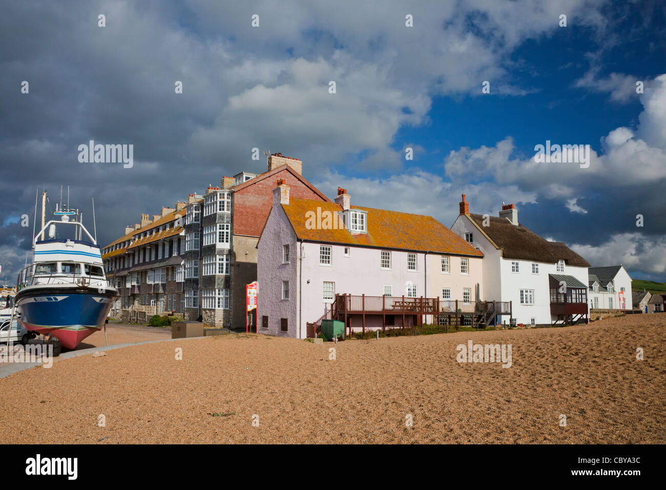 Seafront cottages on the shingle beach at West Bay near Bridport in Dorset, England, UK Stock Photo