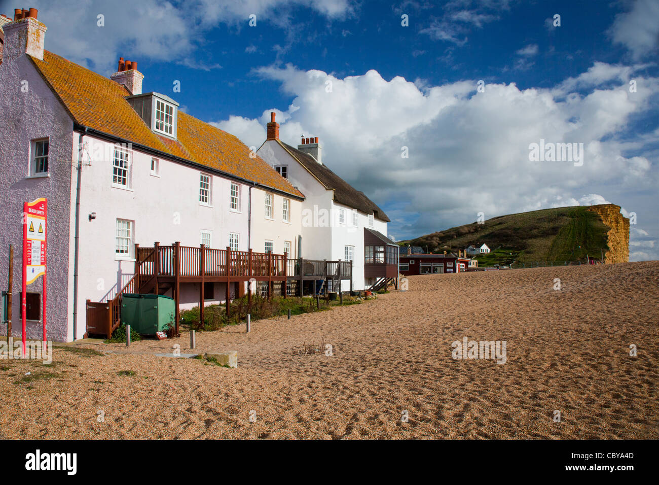 Seafront cottages on the shingle beach at West Bay near Bridport in Dorset, England, UK Stock Photo