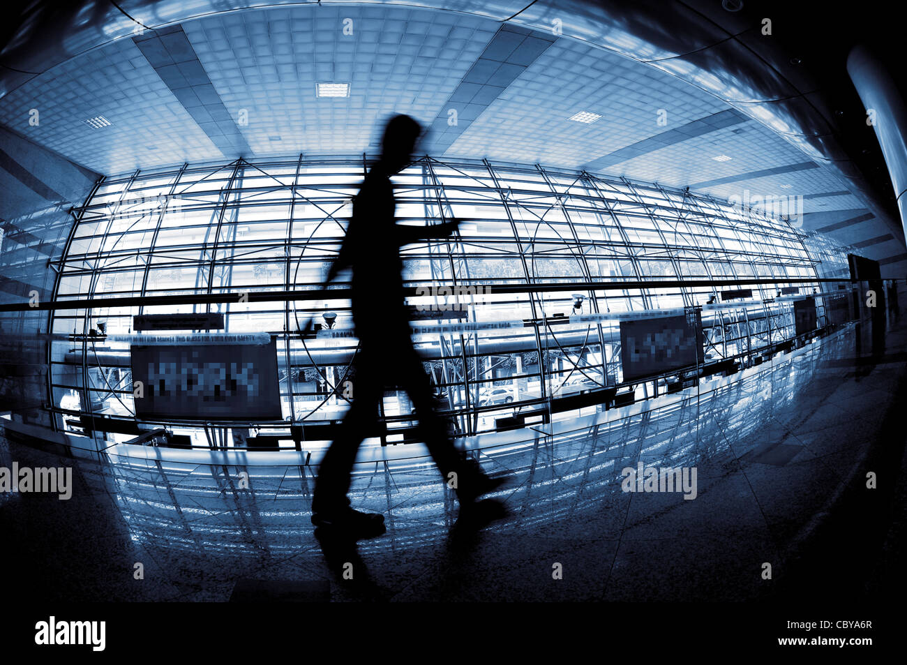 People silhouette walking through in modern building, in fish eye view. Stock Photo
