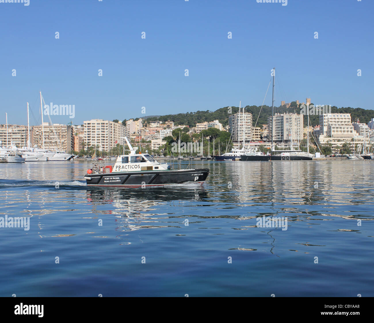 Scene in the Port of Palma de Mallorca with Practicos / Marine Pilot launch passing Paseo Maritimo, Palma de Mallorca / Majorca Stock Photo