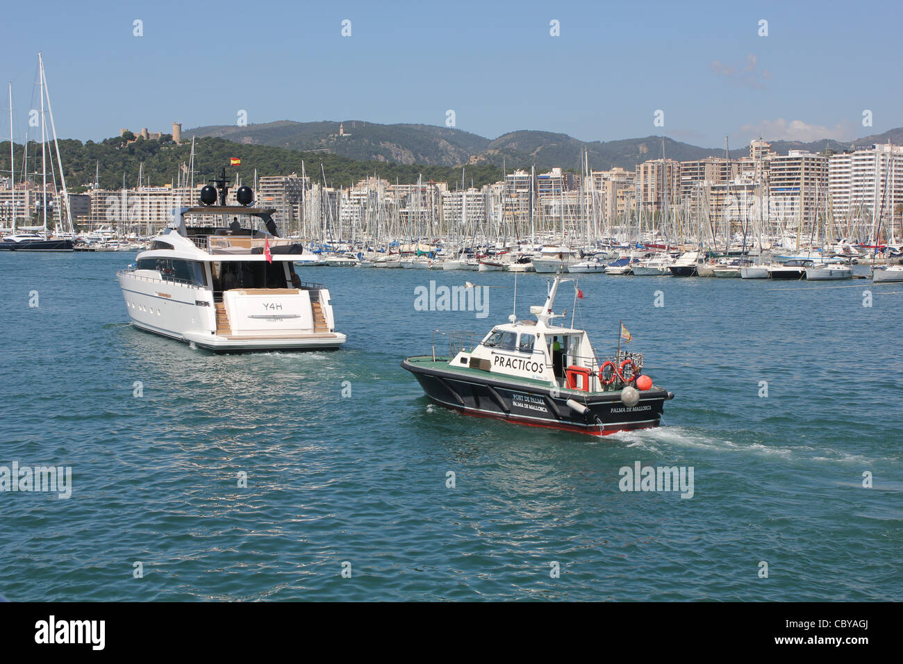 Scene in the Port of Palma de Mallorca - Practicos / Marine pilot launch following Sanlorenzo SL104 luxury superyacht Stock Photo