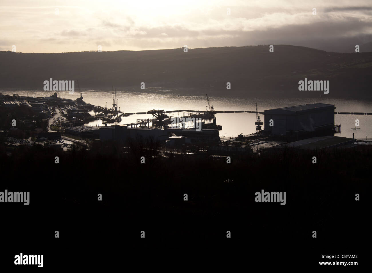 Area of the Gare Loch, Scotland. Silhouetted view of the Royal Navy submarine base at Faslane on the Gare Loch. Stock Photo