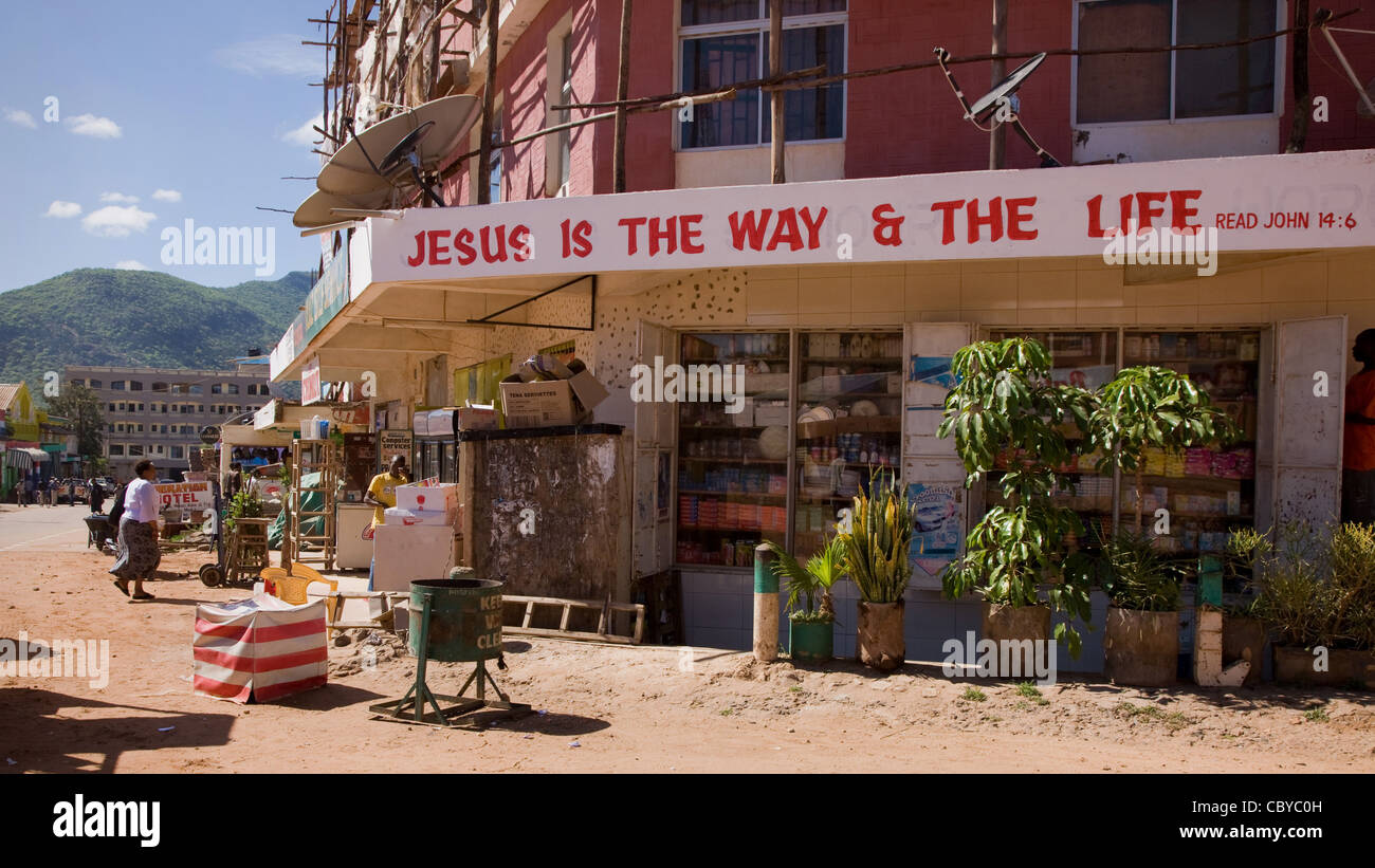 Religious slogan on an arcade of shops in the bustling town of Voi in southern Kenya Stock Photo