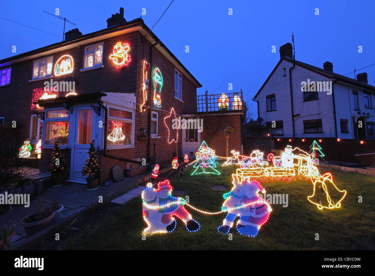 night photograph of UK suburban house home, with illuminated external Christmas decorations, Suffolk, UK Stock Photo