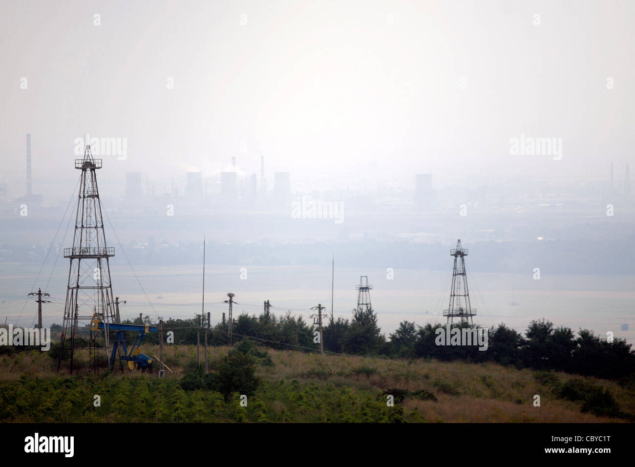 Oil field with oil pumps on a hazy day Stock Photo