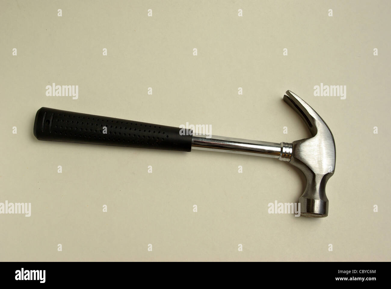 A silver metal hammer is laying on a white background. Stock Photo