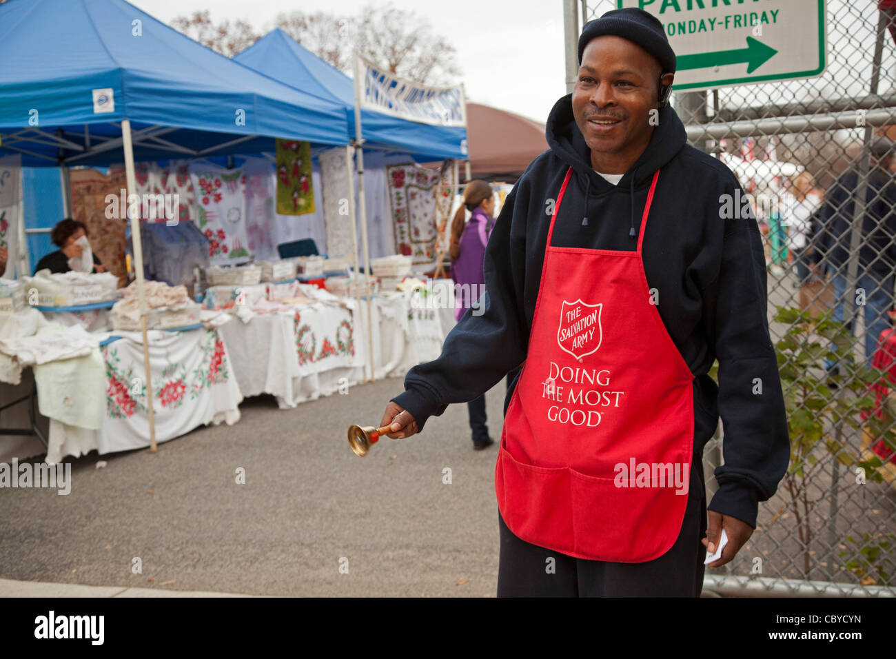 Washington, DC - A 'bell ringer' for the Salvation Army solicits donations for the religious charity outside a flea market. Stock Photo