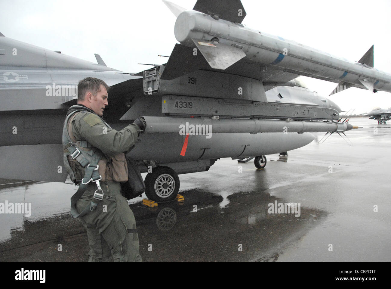 Capt. Matt Hepp conducts a preflight inspection of his F-16 Fighting Falcon at from Komatsu Japanese Air Self-Defense Force Base, Japan, Dec. 7, 2010, before a mission over the Sea of Japan. More than 160 Airmen from Misawa Air Base, Japan, are deployed to Komatsu from Dec. 3 to 11 in support of Exercise Keen Sword 2011. Captain Hepp is a pilot with the 14th Fighter Squadron. Stock Photo