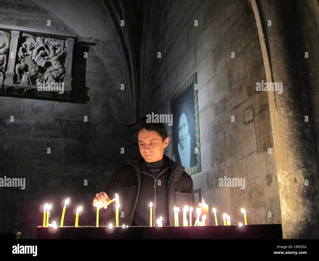 Lighting a Candle in a Church Stock Photo Alamy