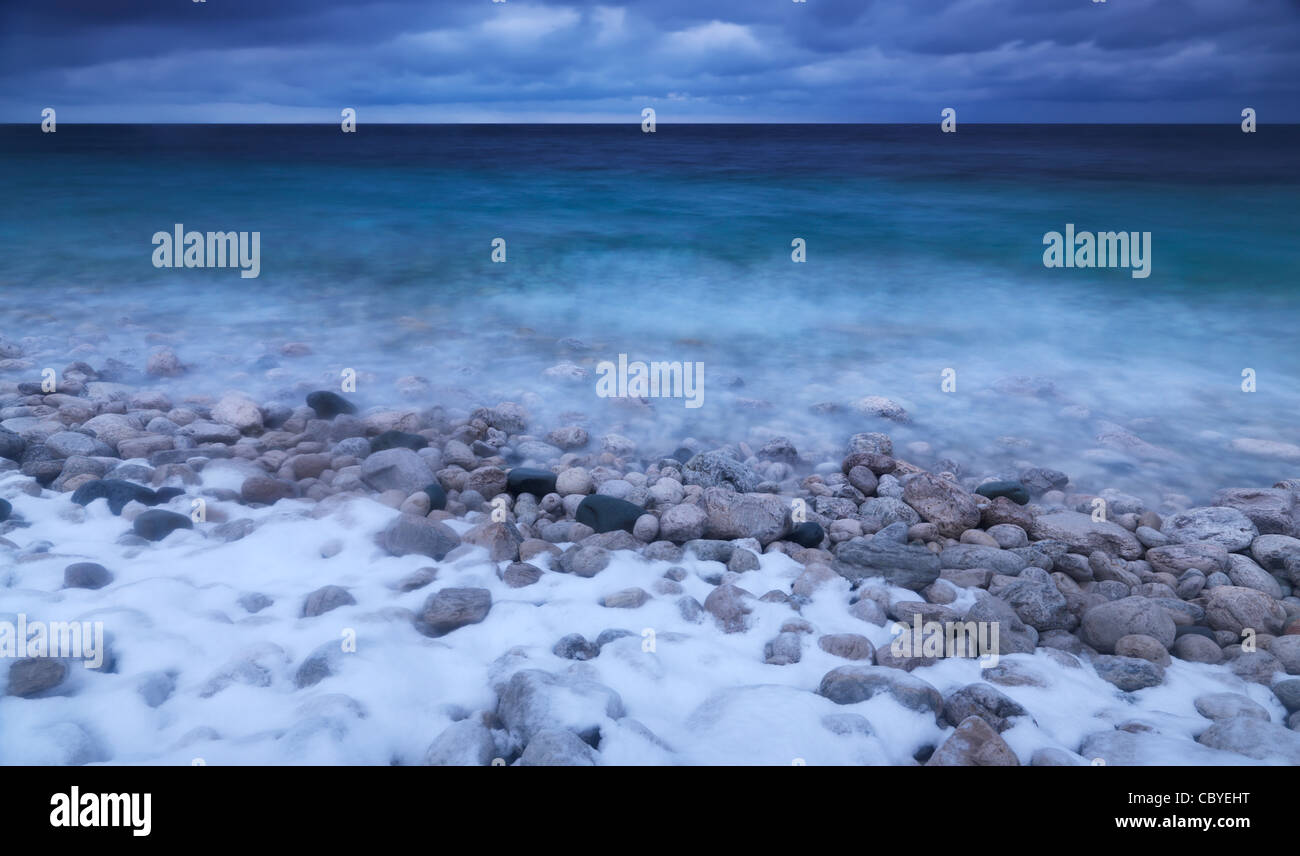 Wintertime scenery of covered with snow pebbles on a shore of Georgian Bay. Bruce Peninsula National Park, Ontario, Canada. Stock Photo