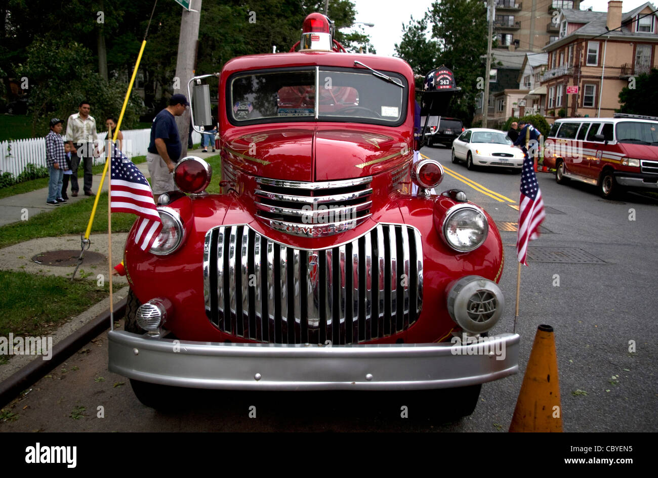 Antique American bright red 1940's Chevrolet fire truck on neighborhood display honoring those lost on 9/11 9-11. Stock Photo