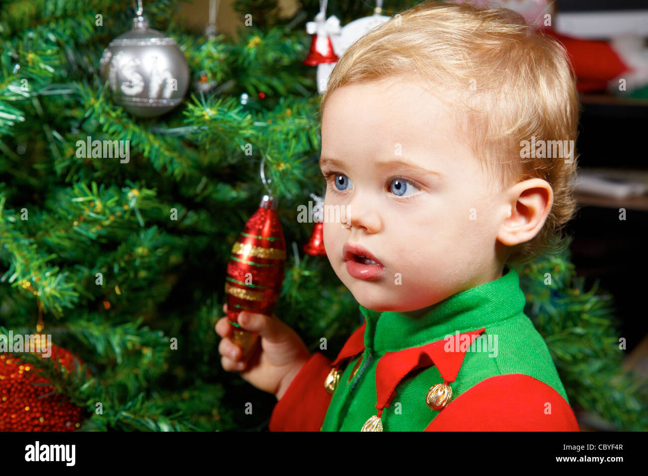 1 year old baby boy portrait by the Christmas tree. Stock Photo