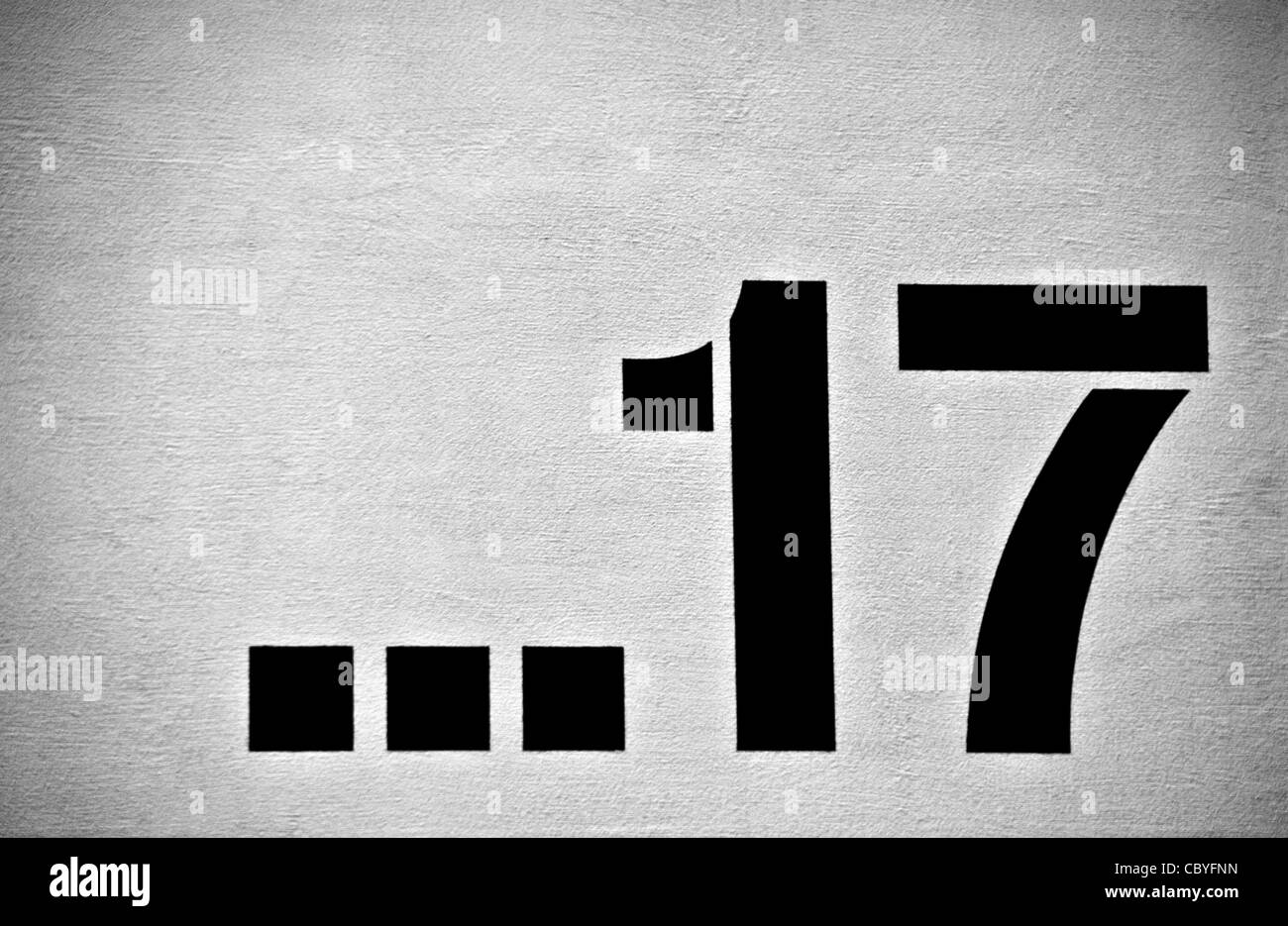 a number on a urban wall in black and white Stock Photo
