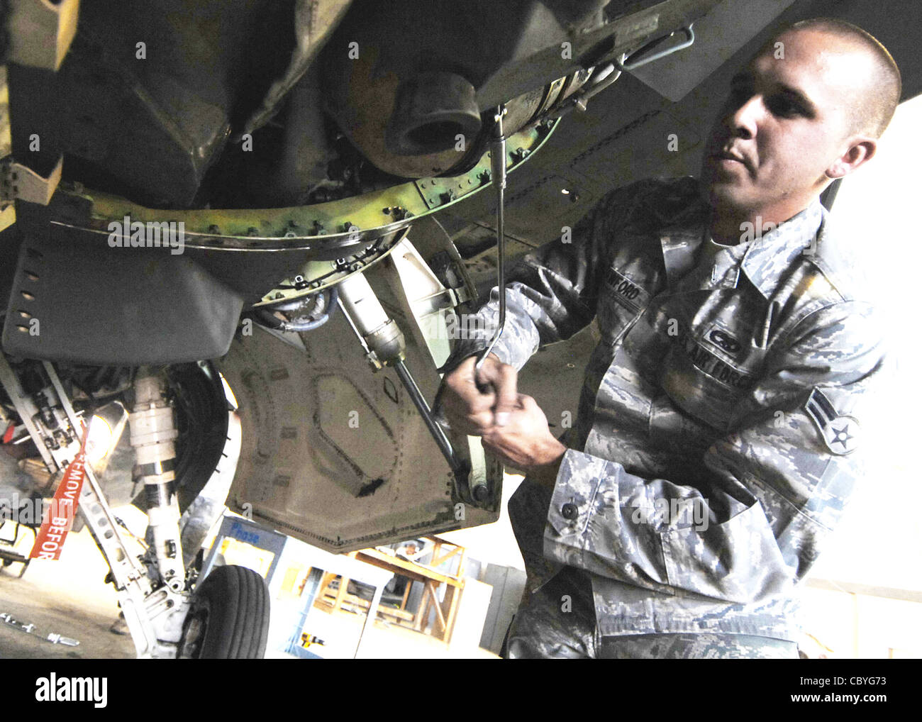 Airman 1st Class Kyle Crawford, 332nd Expeditionary Maintenance Squadron electronics and environmental systems specialist, installs parts of a new environmental control system for an F-16 Fighting Falcon Oct. 20, 2009 at Joint Base Balad, Iraq. Electronics and environmental systems specialists are responsible for all environmental control and oxygen generating systems on the F-16. Stock Photo