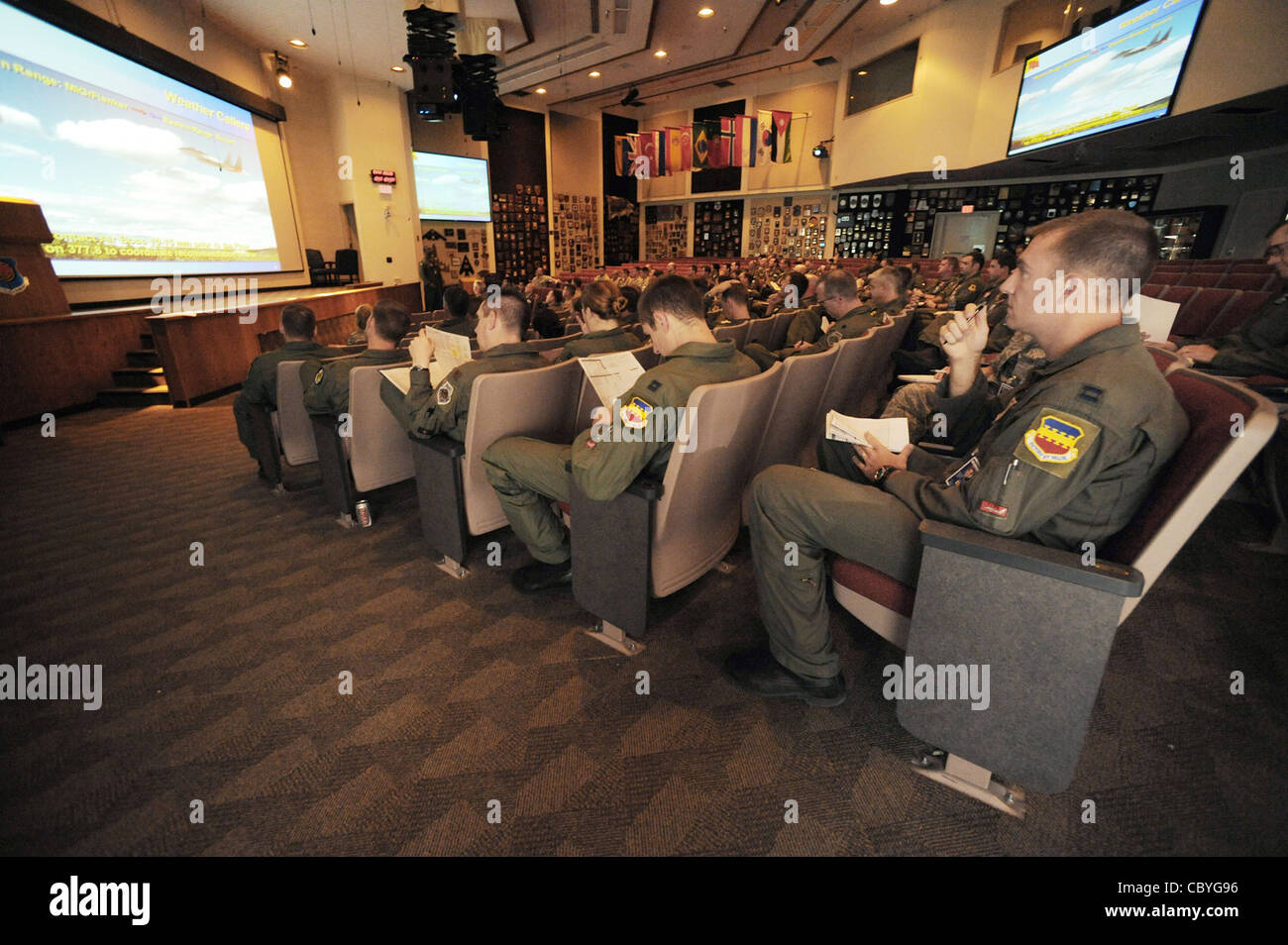 Capt.Taylor Blevins sits in the mass briefing room with approximately