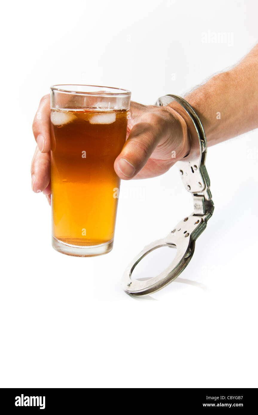 Alcoholic Drink Held in Hand with Cuffs Stock Photo