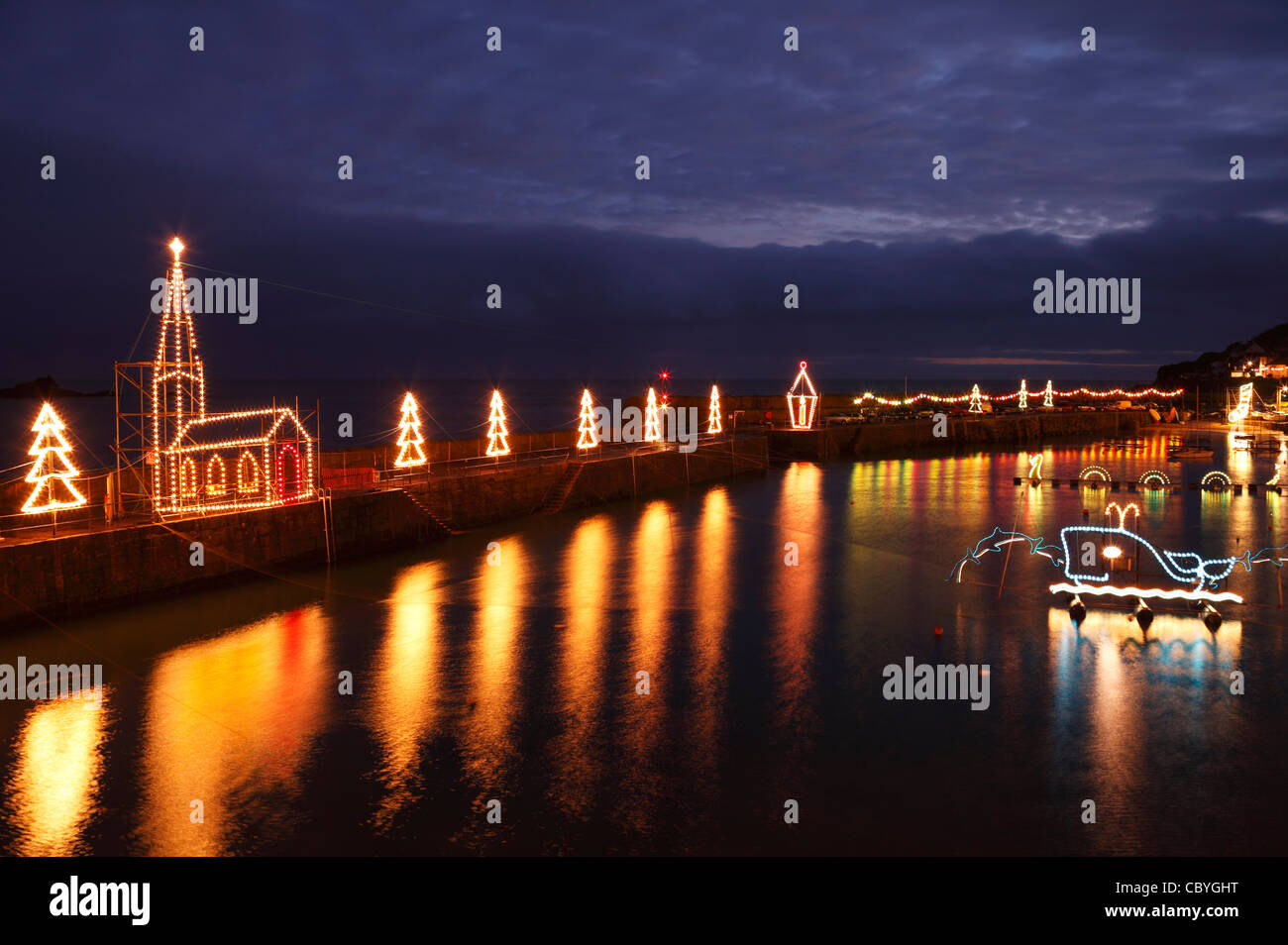 Mousehole Christmas lights, winter illuminations reflected in water at