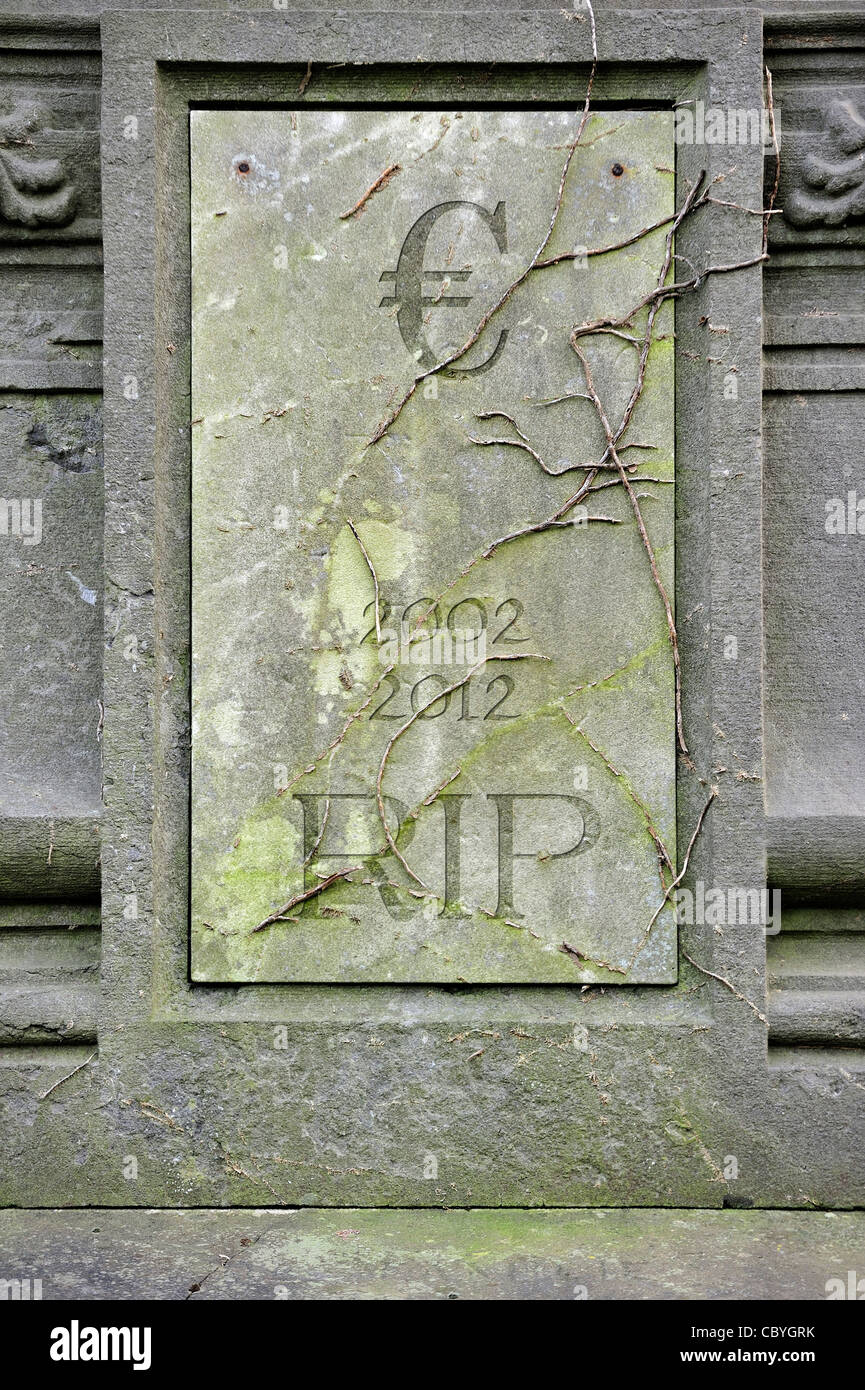 Conceptual grave with € and RIP engraved for symbolic death of European euro due to financial crisis and bank debt in Europe Stock Photo