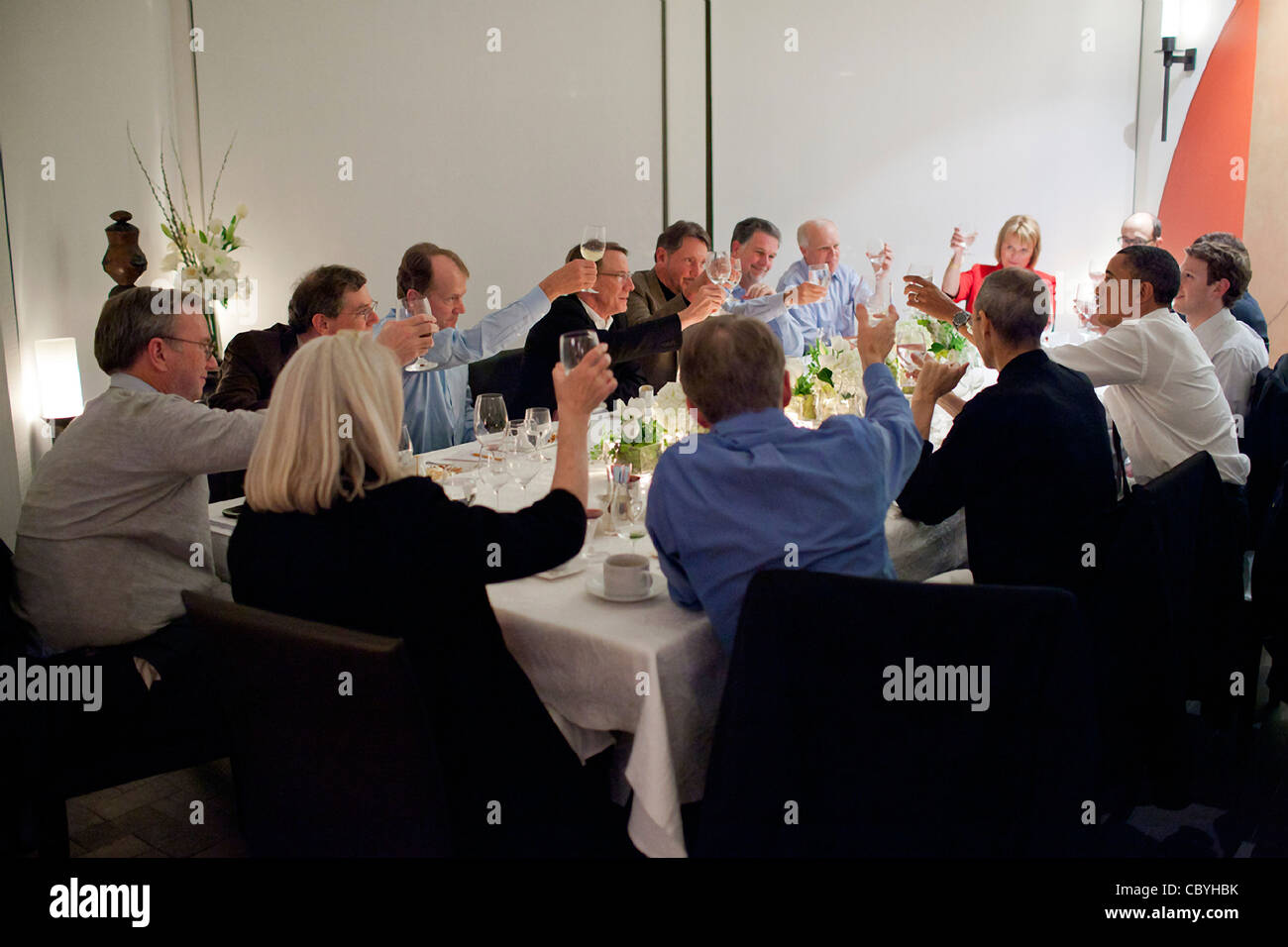 President Barack Obama joins a toast with technology business leaders at a dinner February 17, 2011 in Woodside, CA. Among those attending were the late Steve Jobs, to the President's left, and Facebook founder Mark Zuckerberg, to the President's right. Stock Photo