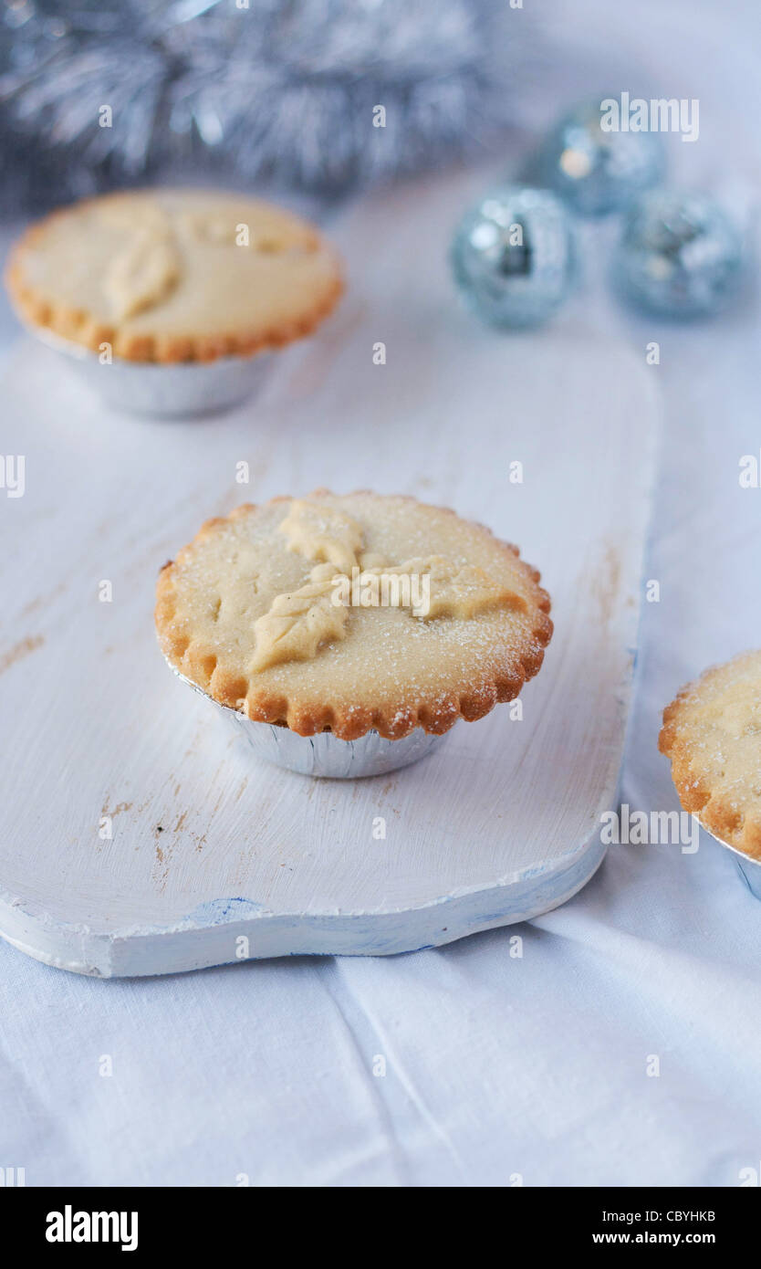 Homemade minced pies on a chopping board Stock Photo