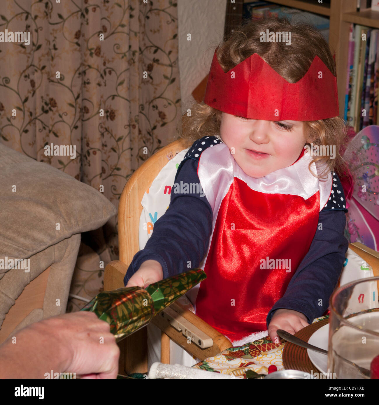 3 Year Old Child Girl Infant Toddler Pulling A Christmas Xmas Cracker Stock Photo