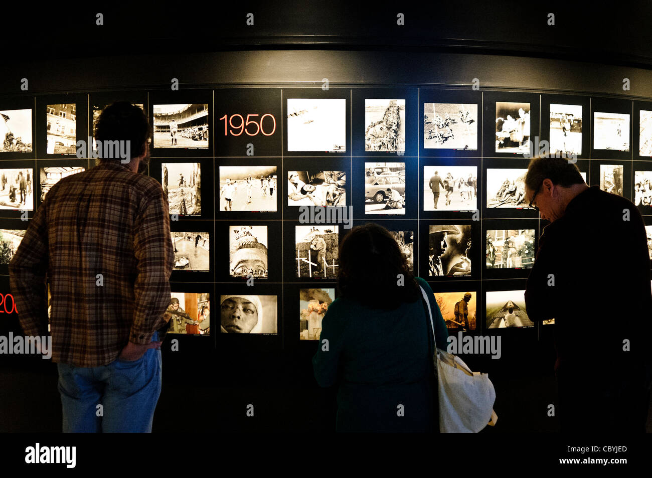 WASHINGTON DC, USA - Visitors view an exhibition of all the Pulitzer Prize winning photographs in the Newseum in downtown Washington DC. The Newseum is a 7-story, privately funded museum dedicated to journalism and news. It opened at its current location on Pennsylvania Avenue in April 2008. Stock Photo