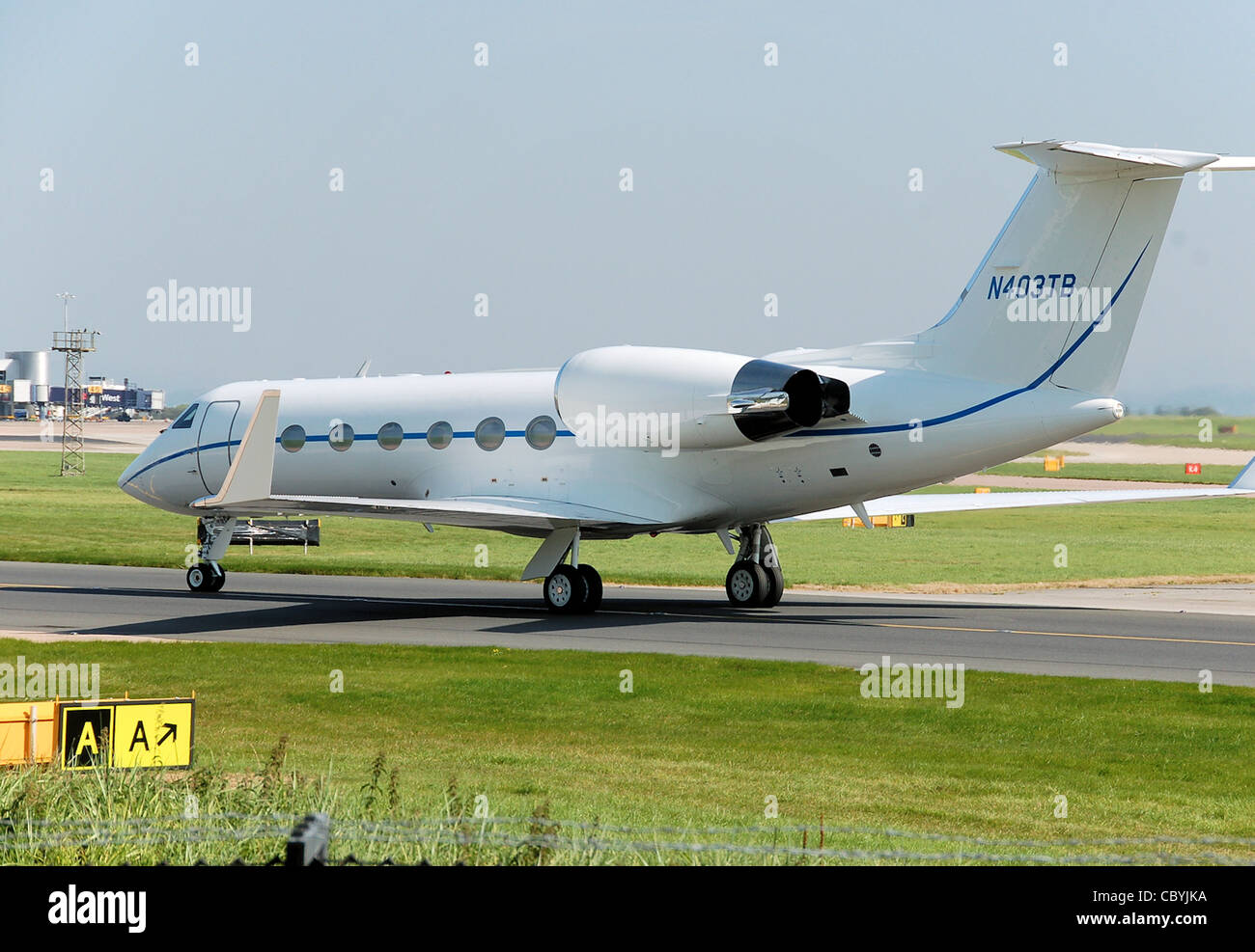 Gulfstream G-IV business jet (N403TB) taxis past the Aviation Viewing Park, after landing at Manchester Airport, England. Stock Photo