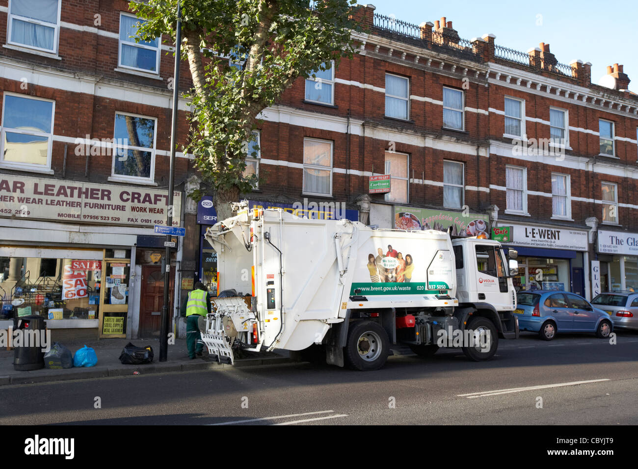 veolia workers working on behalf of local brent council collecting refuse waste in a bin lorry london uk united kingdom Stock Photo