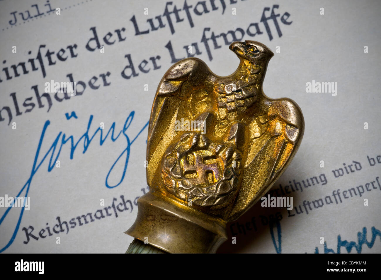 Ceremonial military baton crested with gold eagle and Nazi Swastika on Luftwaffe WW2 document signed by Reichsmarschall Goering Stock Photo