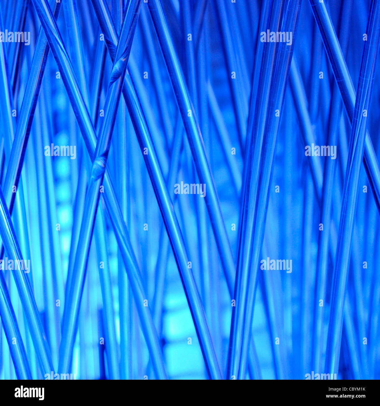 Blue abstract background of a blue lighting display applied to leaning rods & bars in random irregular crisscross pattern replicating technology theme Stock Photo