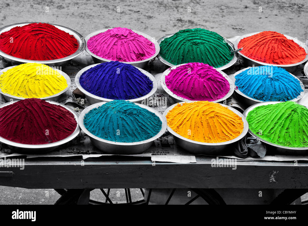 Coloured Indian powder in metal bowls used for making rangoli designs at festivals. Spot coloured onto black and white Stock Photo