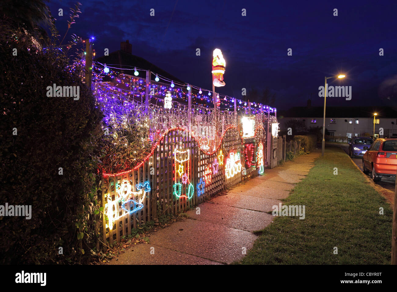 illuminated Christmas decorations, UK House at night, Saxmundham, Suffolk Stock Photo