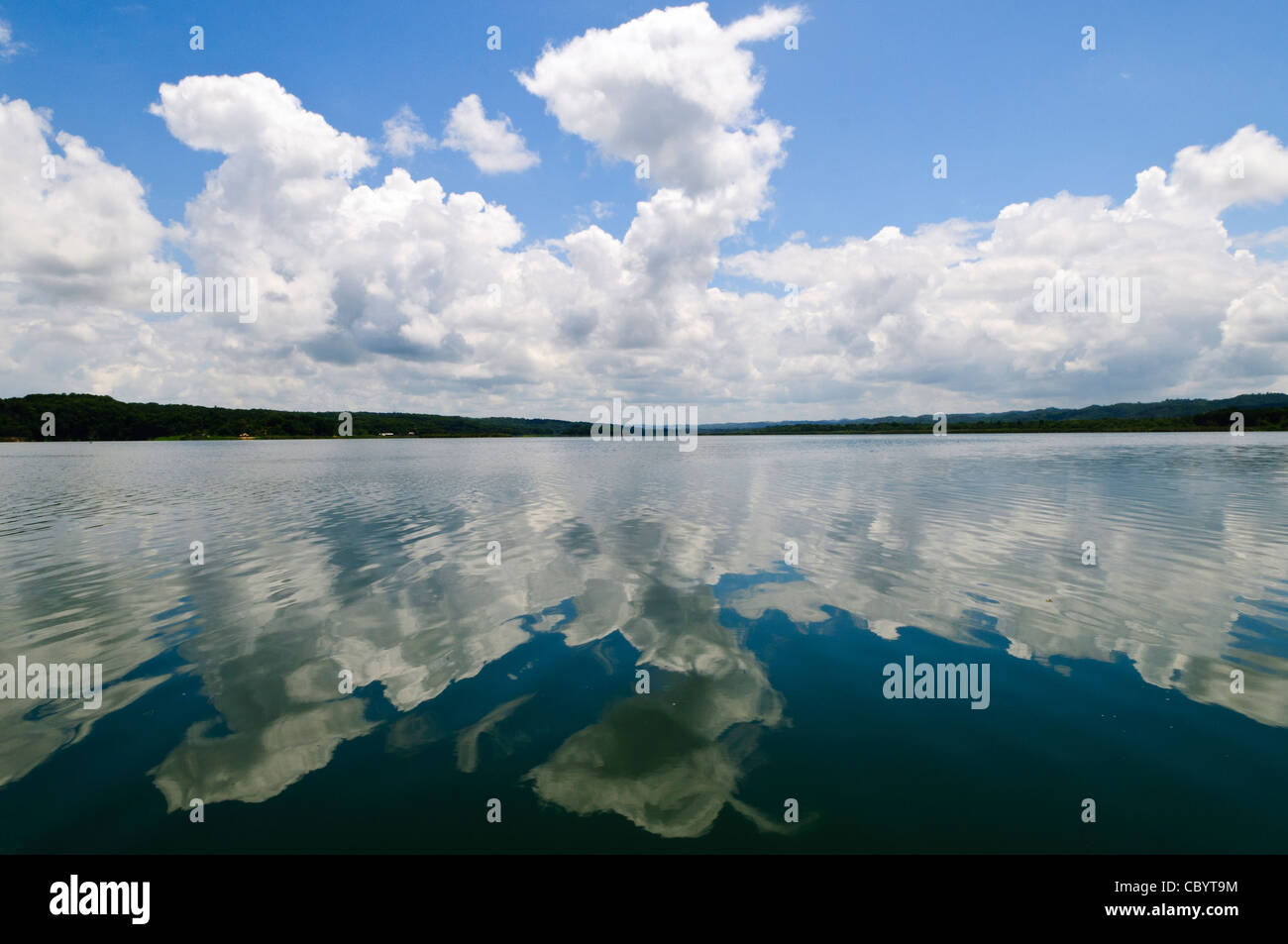 FLORES, Guatemala - Clouds and sky reflected on the smooth surface of Lake Peten Itza near Flores, Peten, Guatemala. Stock Photo