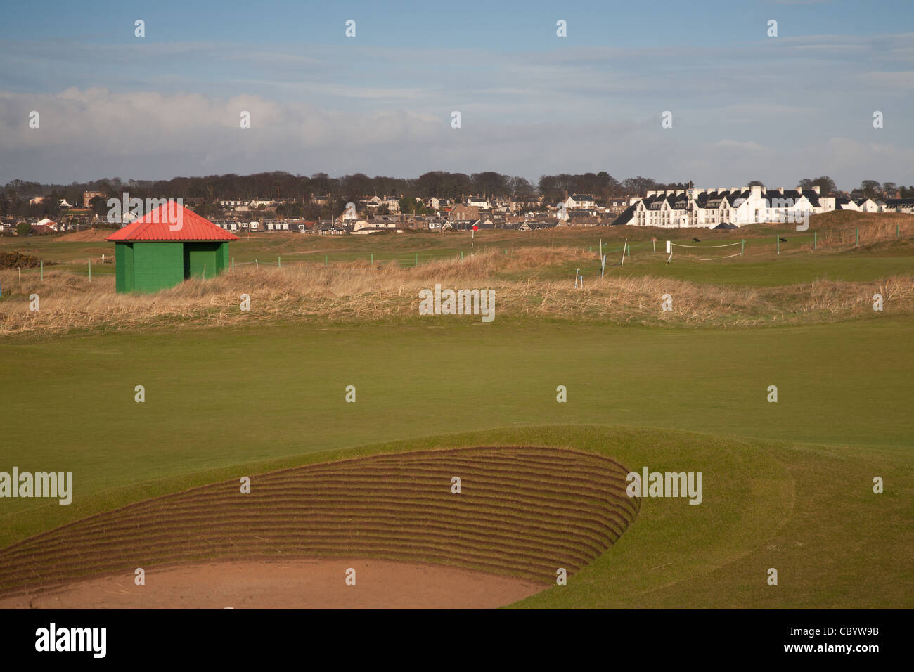 Looking over Carnoustie Golf Course past one of the green and red shelters to the Hotel Stock Photo
