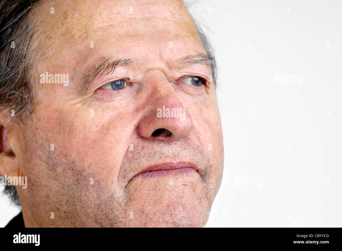 Portrait of a senior man with blue eyes looking away with hint of a smile, great facial details, over white. Stock Photo