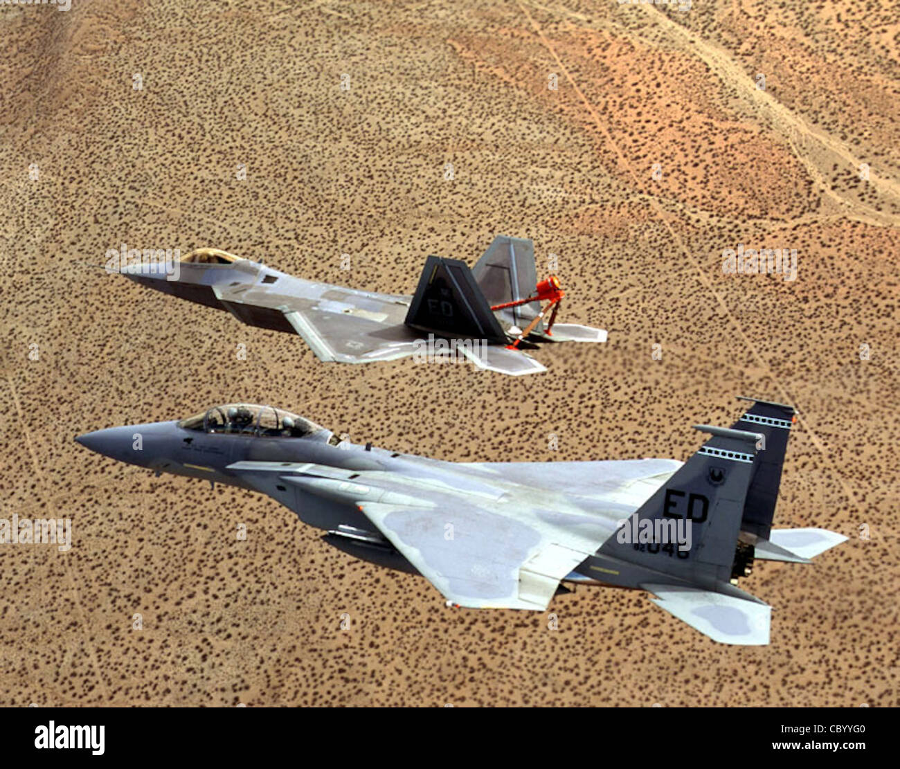 EDWARDS AIR FORCE BASE, Calif. -- An F-22 Raptor is shadowed by an F-15 ...