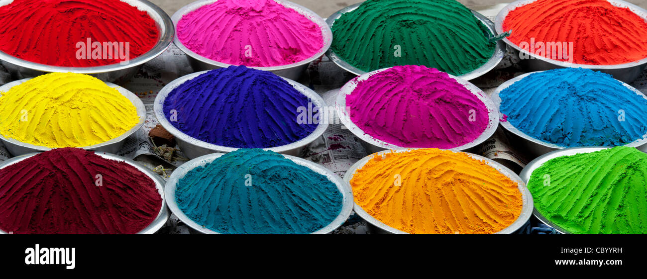 Coloured Indian powder in metal bowls used for making rangoli designs at festivals. Panoramic Stock Photo